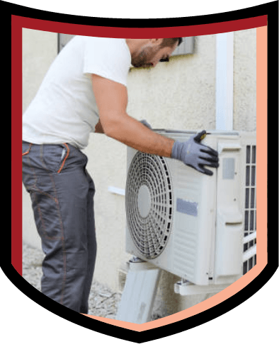 Technician installing air conditioning unit outside