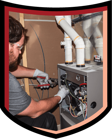 Technician performing maintenance on a furnace system